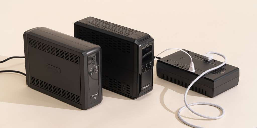 Three black UPS units and a power strip