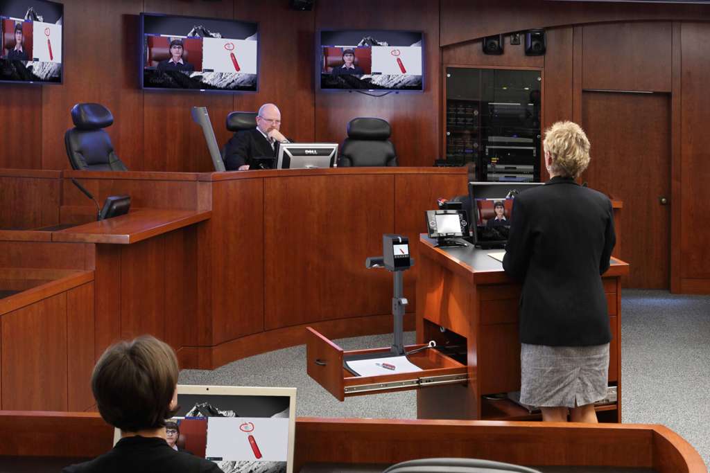 A modern courtroom with digital evidence displays