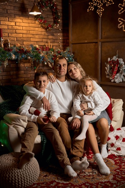 A family of four posing for a festive holiday portrait